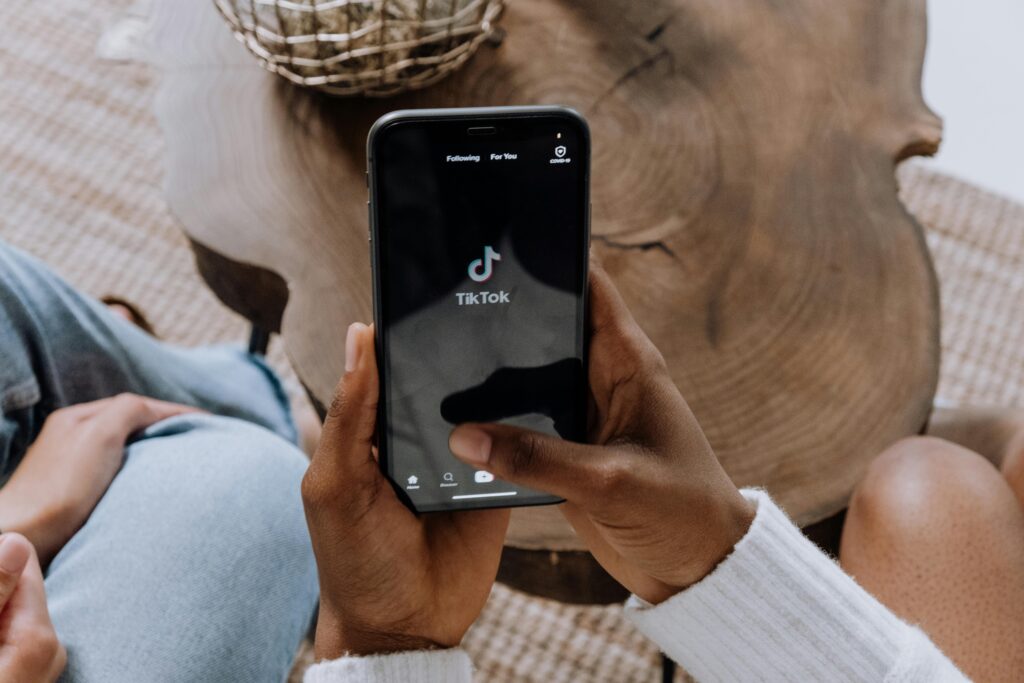 alt_text: "A vibrant cover image showing a person on TikTok in the UK,."